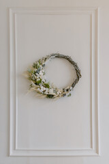 Beautiful Christmas white wreath with cones