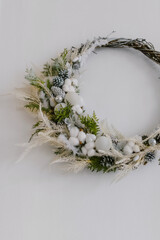 Beautiful Christmas white wreath with cones