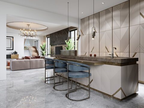 A chic modern kitchen with a designer beige front with gold accents and a trendy kitchen island with three chairs.