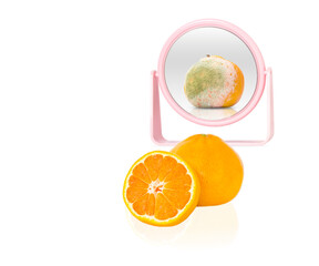Reflection in the mirror of a rotten tangerine. Bad-good concept.