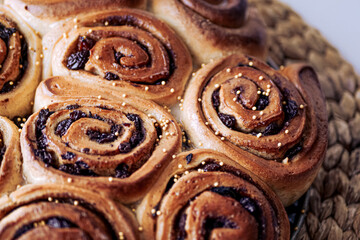 Fototapeta premium Homemade cinnamon rolls made from yeast dough, Chelsea rolls with cinnamon and raisins. Homemade snail buns 