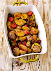 Oven baked vegetables in a baking dish. Vegetable dish close-up. Assorted vegetables roasted with spices, vegan recipe, copy space