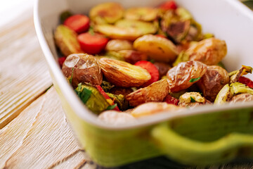 Oven baked vegetables in a baking dish. Vegetable dish close-up. Assorted vegetables roasted with spices, vegan recipe, copy space