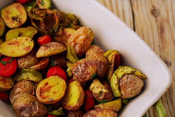 Oven baked vegetables in a baking dish. Vegetable dish close-up. Assorted vegetables roasted with spices, vegan recipe, copy space