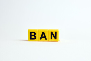 The word ban consists of individual cubes with letters.