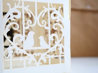 romantic white paper birds in a heart close up