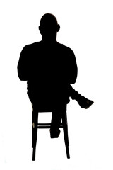 rear view of silhouette of the man sitting on chair