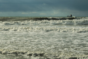 Fototapeta na wymiar seething surf in stormy weather near the coastline