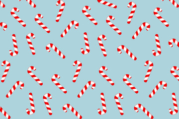 Christmas candy canes on a blue background. Gift wrapping design paper, prints for cards, fabric, fabric, wallpaper, clothing, textiles, wallpaper. New Year and Christmas backgrounds and textures.
