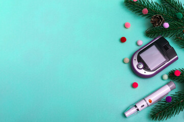 Christmas banner with holiday decorations and a glucometer for measuring blood sugar on a colored...