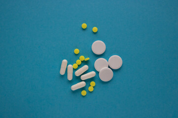 Medicines, pills and pills on a blue background. The concept of medicine and treatment.