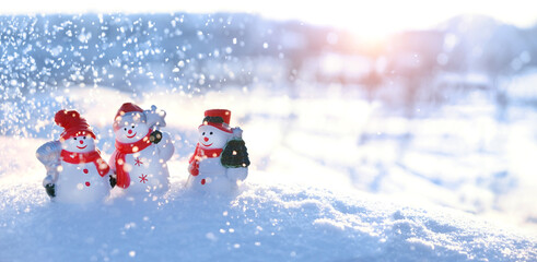 cute snowman friends on snowy landscape, natural background. Christmas and new year holidays...