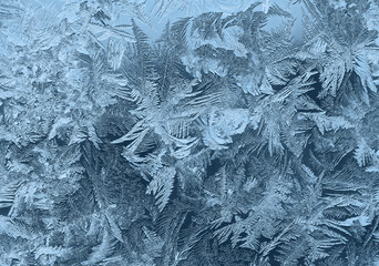 Icy pattern on window glass in frosty day