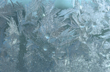 Icy pattern on window glass in frosty day