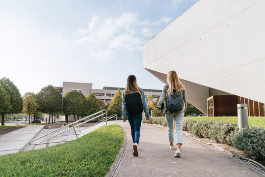 Two College Classmates Leaving The University Together While Talking