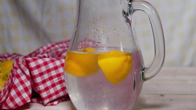 Fresh sliced lemons in pitcher of water