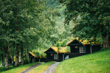 Traditional Norwegian Old Wooden Houses With Growing Grass On Roof. Cabins In Norway