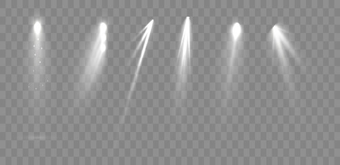 Spotlights set isolated on transparent background. Vector glowing light effect with golden rays and lens flares.