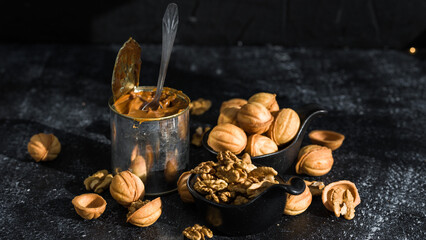 Cookies nuts with condensed milk against the background of New Year's garlands. New Year's sweets on a dark background. Homemade pastries. tin can with condensed milk.
