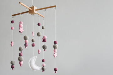 Baby crib mobile with stars, planets and moon. Kids handmade toys above the newborn crib. First...