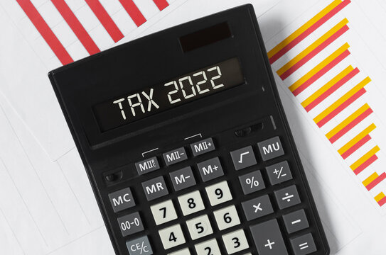 Tax 2022 concept. Word on calculator and documents
