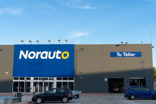 Norauto workshops, with some cars parked in the parking lot.
