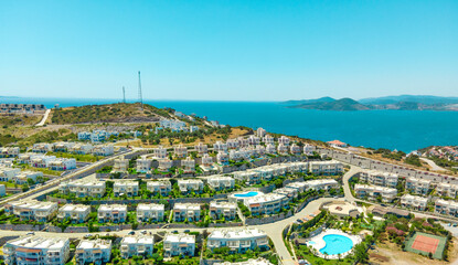 Rich neighborhood and islands landscape with blue sea and sky. Aerial drone view of coastal houses.