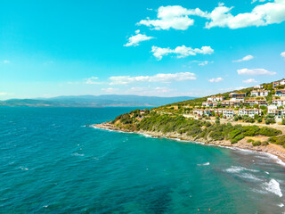 Coastal view of beautiful Aegean sea and seashore. Aerial drone view of summer holiday landscape with blue sky.