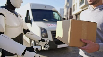 Close up of robot delivering parcel box to recipient. Courier on the way to deliver postal parcel to caucasian client.