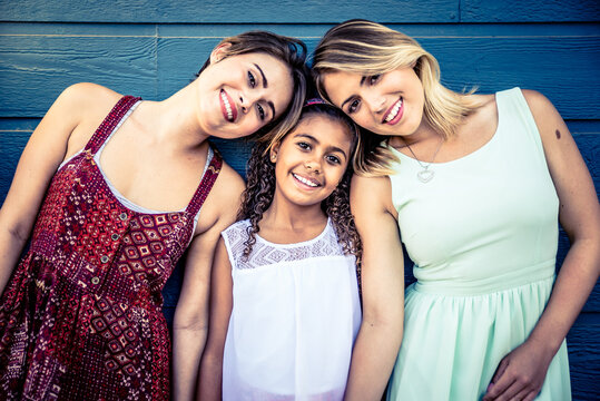 happy gay couple spending time together with their adopted daughter