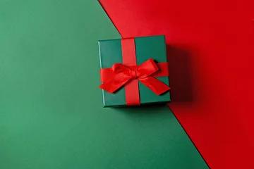 Fotobehang Green box with red bont. Christmas gift on a green red background with space for text. Stylish holiday concept with gift wrapping © Anastasia Studio