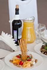 Breadsticks with honey and cheese. Pieces of cheese and walnuts on a plate.