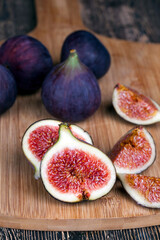 ripe purple figs on a wooden table