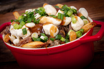 duck confit poutine dish on wood table