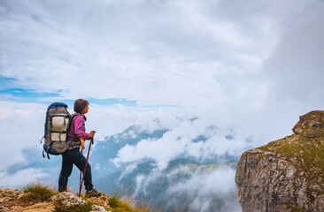 Active hiker hiking, enjoying the view, looking at mountains landscape