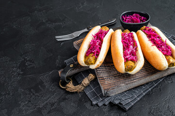 Homemade Vegan hot-dog with meatless Vegetarian sausage and cabbage. Black background. Top view. Copy space