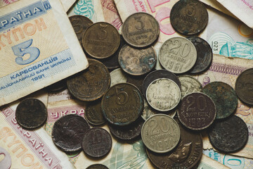 monetary unit of the Ukrainian state coupon and coins of the ussr lie on the table, old soviet...