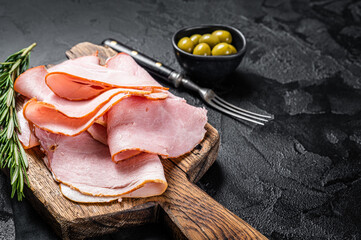 Pork ham slices on cutting board, Italian Prosciutto cotto. Black background. Top view. Copy space - obrazy, fototapety, plakaty