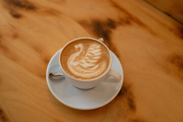 Cup of cappuccino with swan pattern