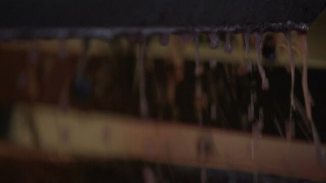 Grapes and juice dropping off a tank after the fermentation. Slow Motion 100