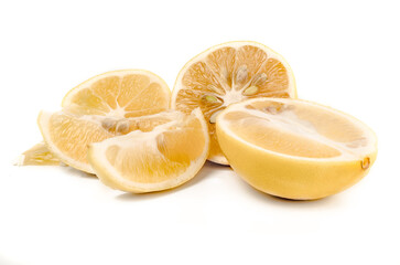 Fresh cut lemon halves and slices on white background