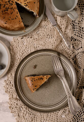 Yeast dough pie with meat, almonds and black grapes on a plate. View from above