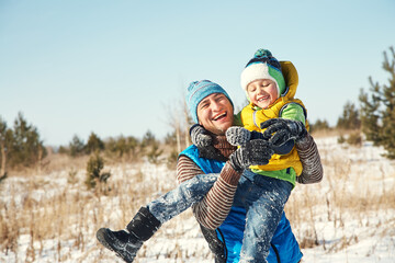 playing father and son in the winter outdoors - 472500597