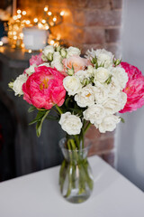 Peonies and roses in a vase