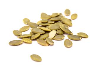 Hulled pumpkin seeds isolated on white background
