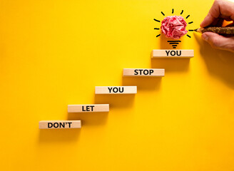 Do not let stop you symbol. Wooden blocks with words Do not let you stop you on beautiful yellow...