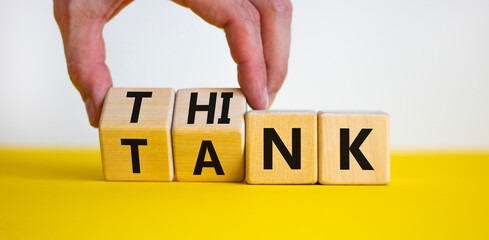 Think tank symbol. Businessman turns wooden cubes and changes the word 'tank' to 'think' or vice...