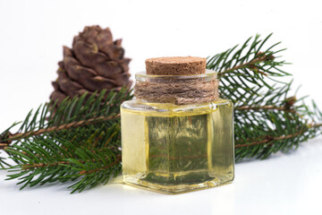 Obraz na płótnie Canvas glass bottle with fir oil, pine cone and fir branch,
