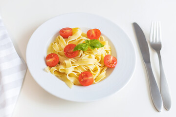 Fresh Italian pasta with cherry tomatoes, cheese and basil. Vegetarian spaghetti. Healthy food.
