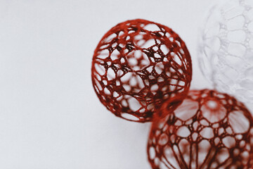 Christmas ball with macrame-style weaving,handmade decor in eco-style,hands close-up,top view. Christmas, New Year and eco-friendly concept